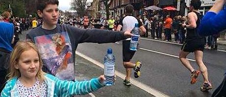 Spectators hand out water at the Sheffield half-marathon.